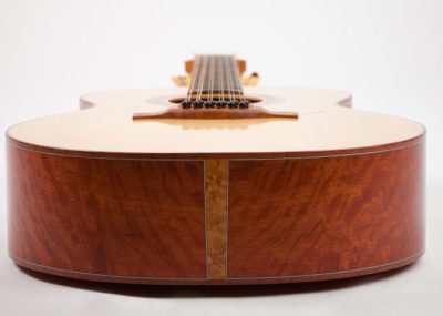 The tail of a 12 string acoustic guitar showing bird's eye maple end graft. Back and sides are Western Australian (WA) She Oak with blue-white-blue perflings.